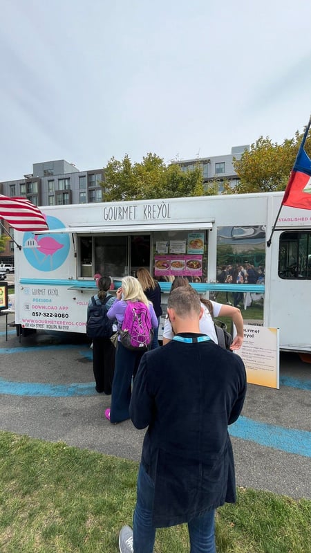 People waiting in line at a food truck at inbound 2024