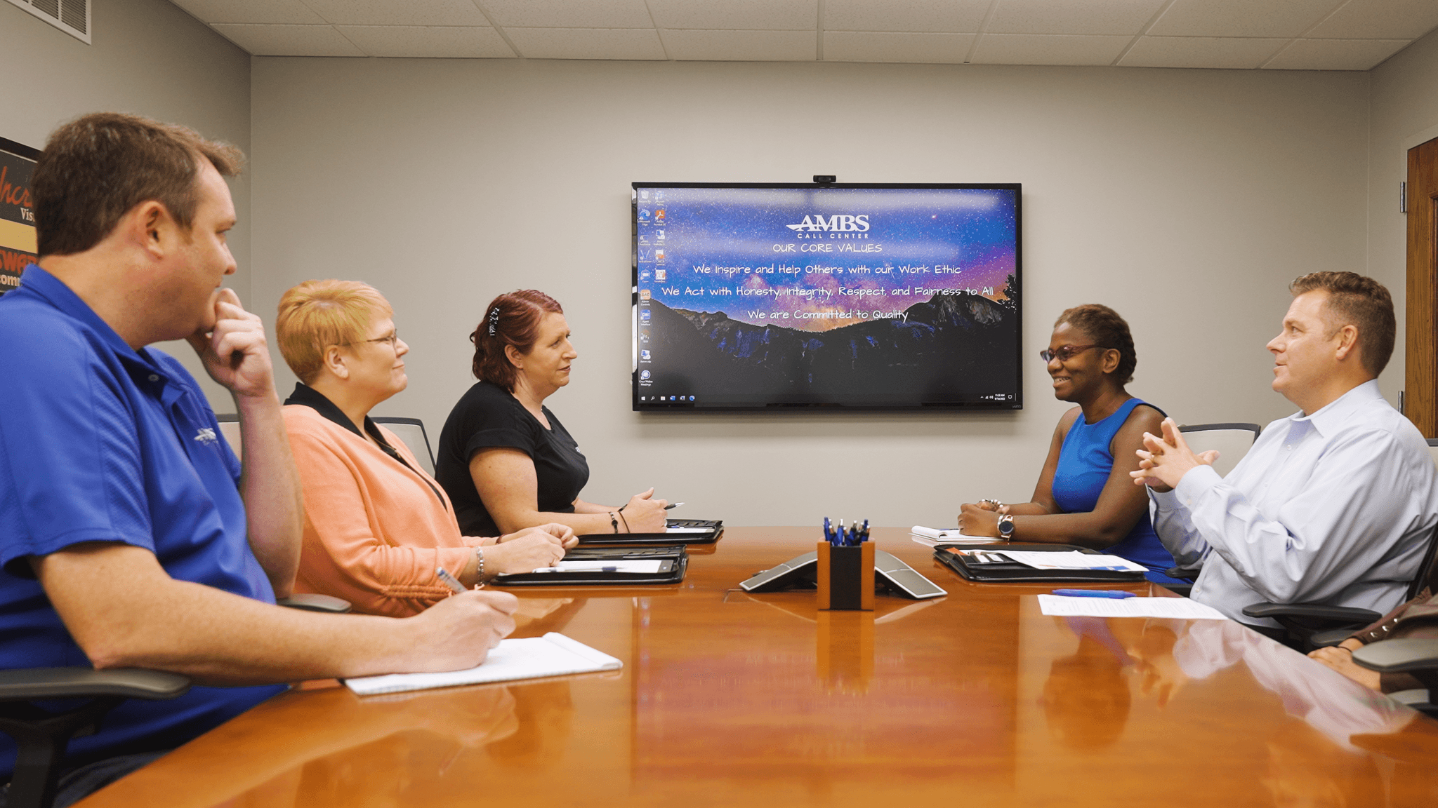 ambs call center's team discussing in conference room