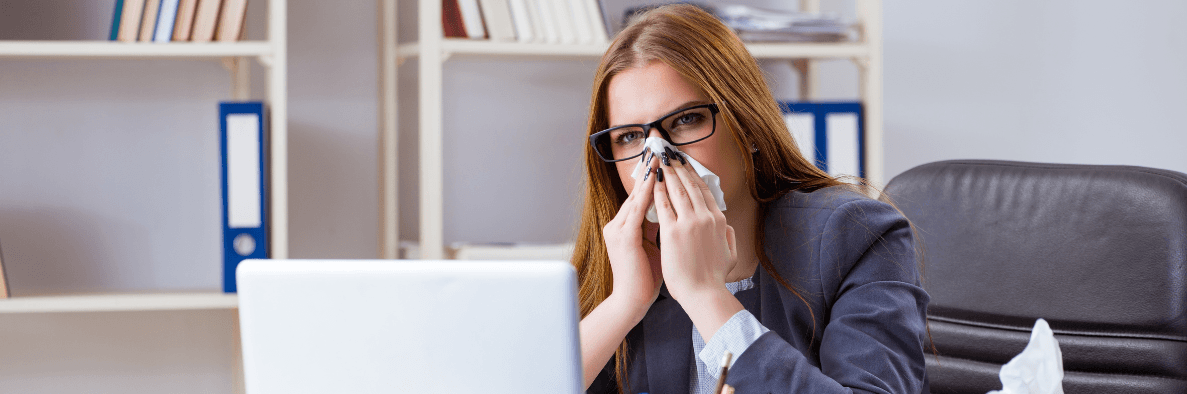 Lady with a cold working from her laptop