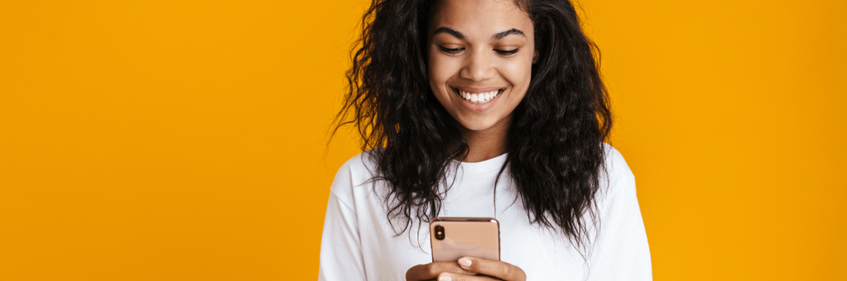 woman smiling while sending a text